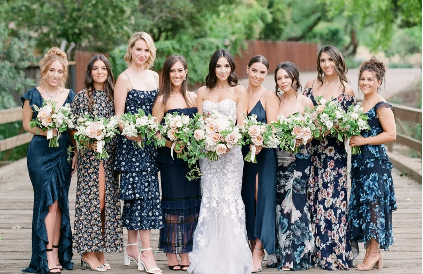 bride with bridesmaids in navy print dresses